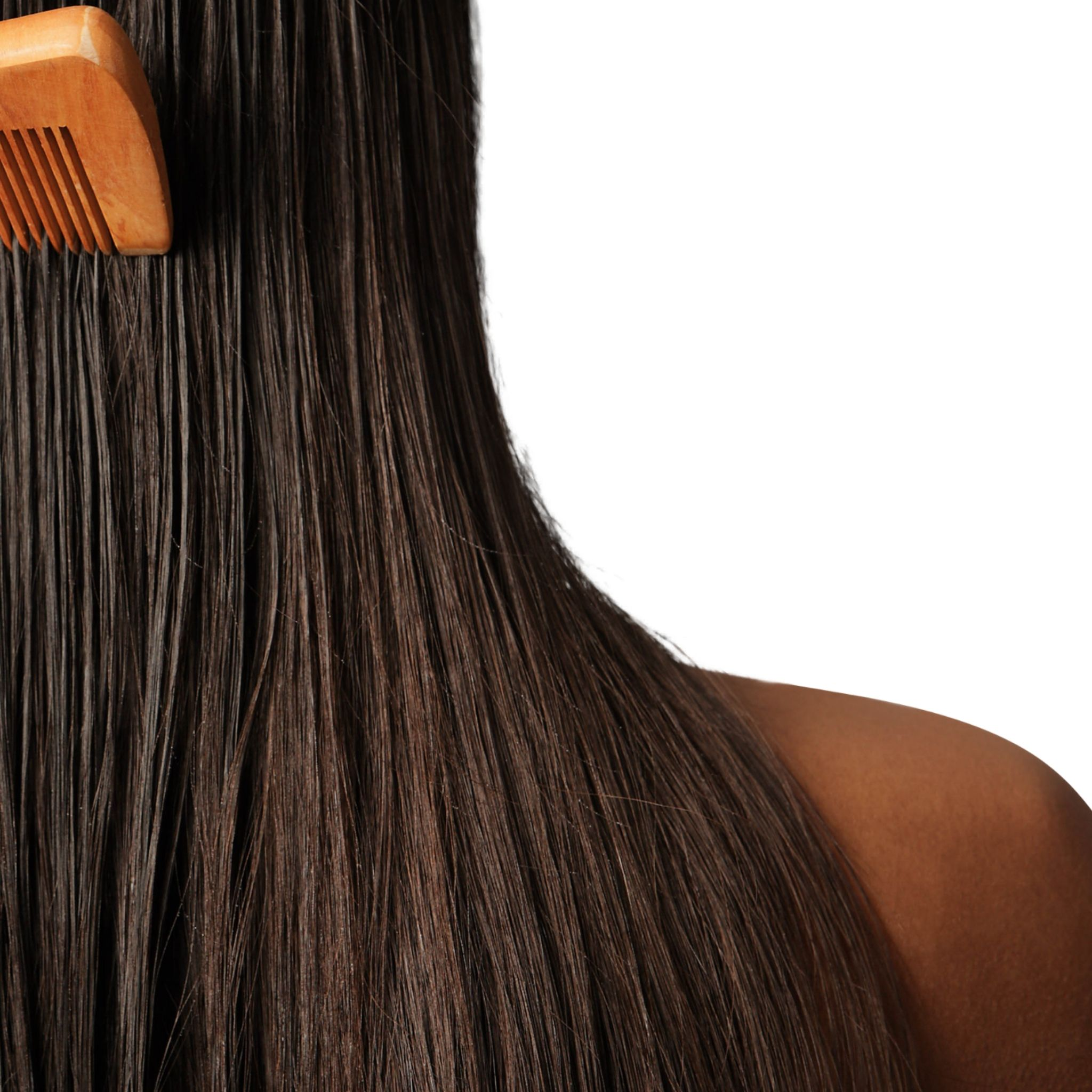 Pure Skin Hair Collection- A woman facing away from us, combing her long brown hair with a natural wood brush